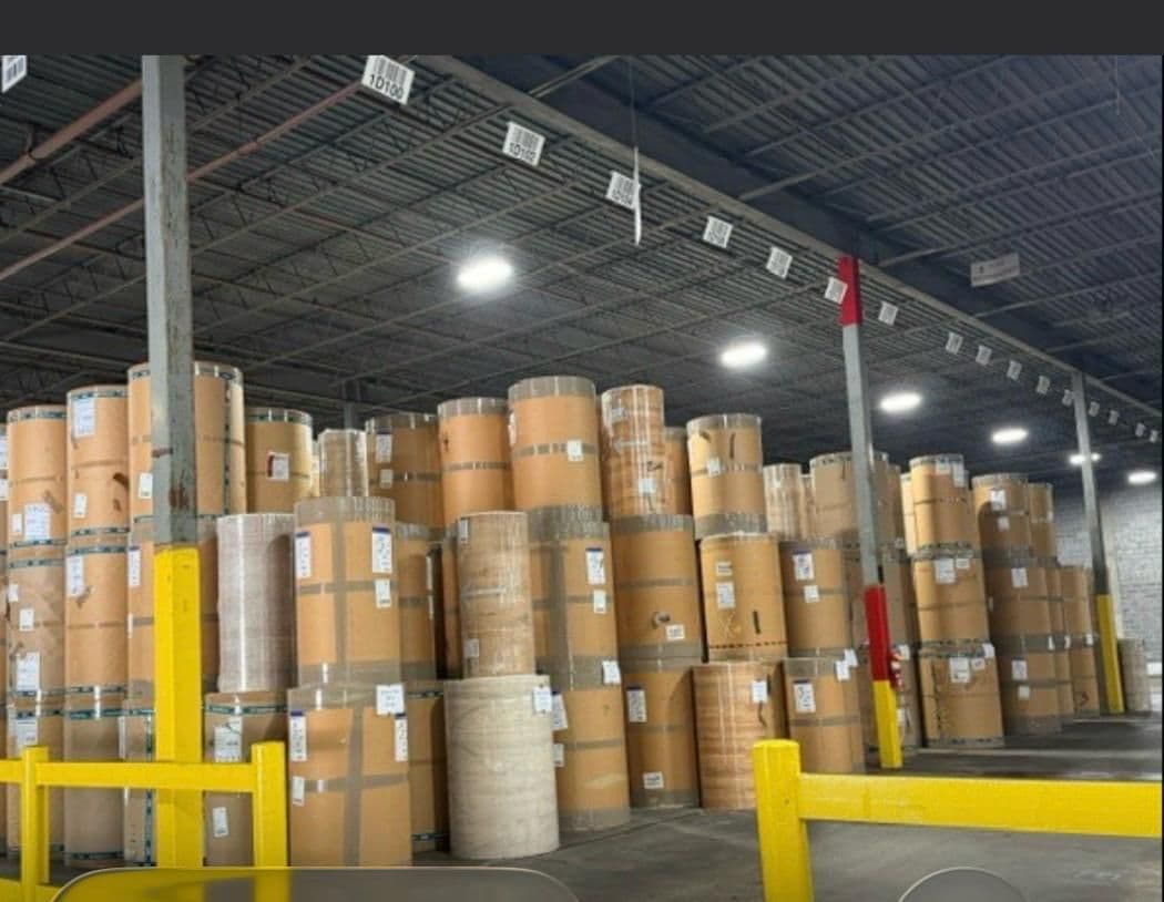 Warehouse stacked with large paper stock rolls