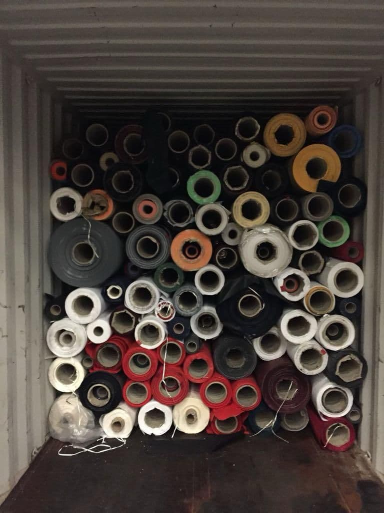 Container packed with paper and material stock-lot rolls