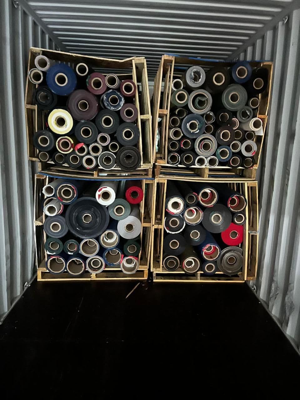 Stacked stock-lot rolls in wooden crates